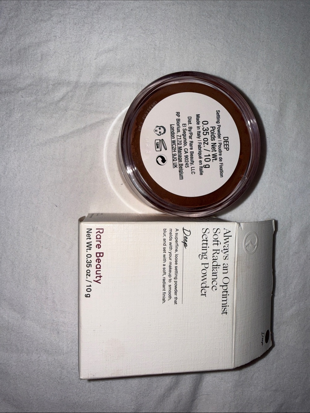 Rare Beauty setting powder in brown and white packaging